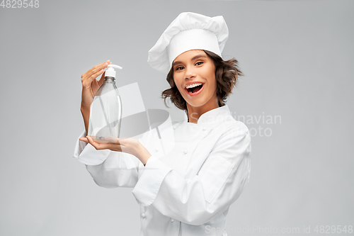 Image of female chef with hand sanitizer or liquid soap