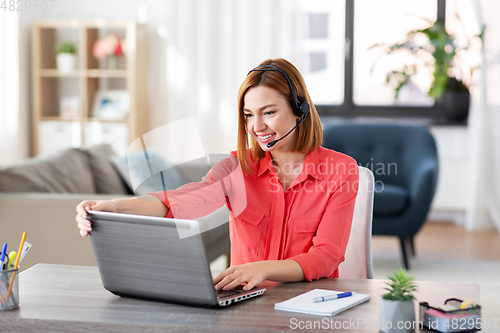 Image of woman with headset and laptop working at home