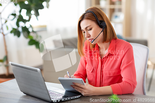 Image of woman with headset and laptop working at home