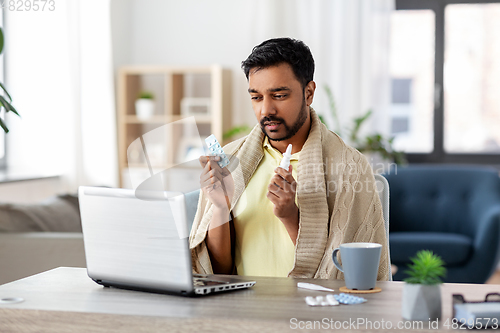 Image of sick man thermometer having video call on laptop