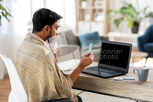 Image of sick man thermometer having video call on laptop