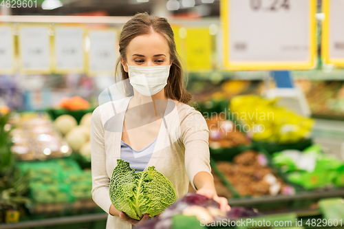 Image of woman in mask buying savoy at grocery store