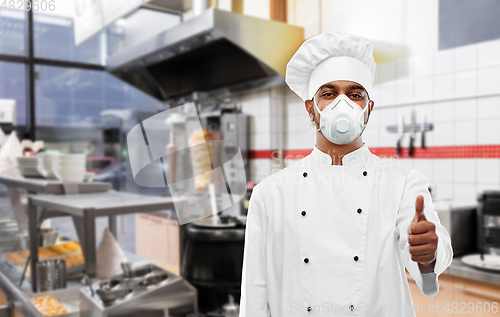 Image of chef in respirator showing thumbs up at kitchen