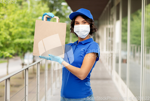 Image of delivery woman in face mask with food in paper bag