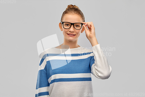 Image of smiling teenage student girl in glasses