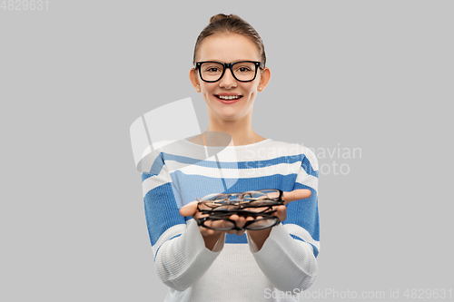 Image of smiling teenage student girl in glasses