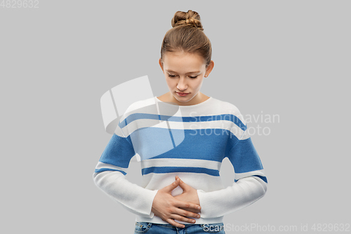 Image of teenage girl having stomach ache