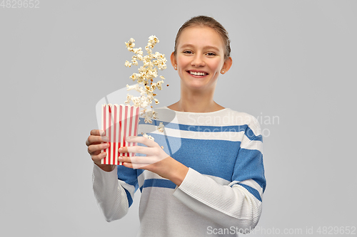 Image of smiling teenage girl with popcorn