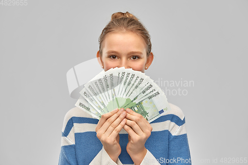 Image of smiling teenage girl with euro money banknotes