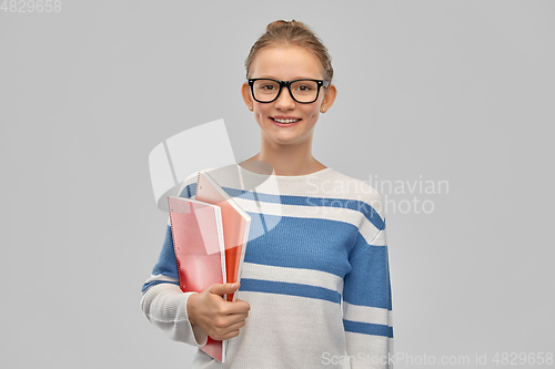 Image of happy smiling teenage student girl with notebooks