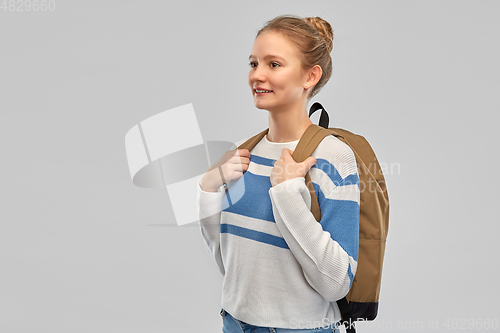 Image of smiling teenage student girl with school bag