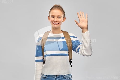 Image of smiling teenage student girl with school bag