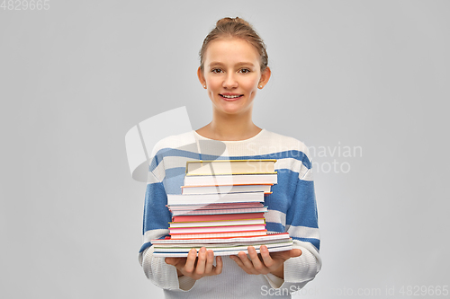 Image of happy smiling teenage student girl with books