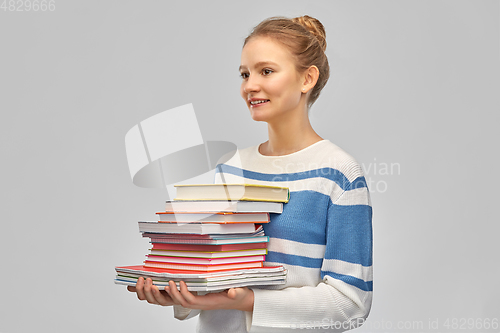 Image of happy smiling teenage student girl with books