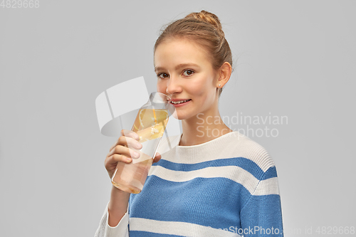 Image of teenage girl with glass bottle of fruit water