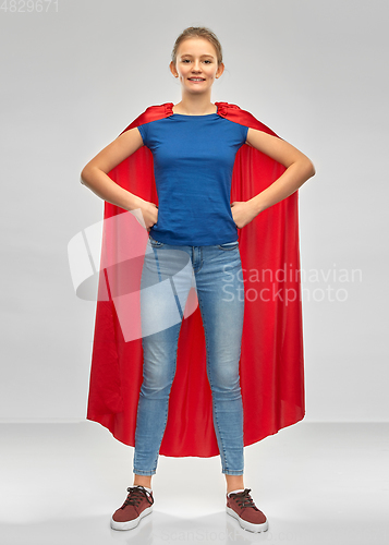 Image of smiling teenage girl in red superhero cape
