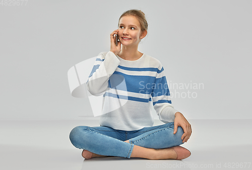Image of happy smiling teenage girl calling on smartphone