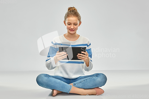 Image of happy smiling teenage girl using tablet computer