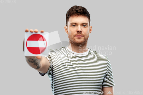 Image of young man showing stop sign