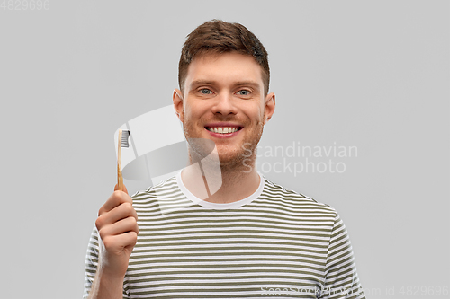 Image of smiling man with wooden toothbrush