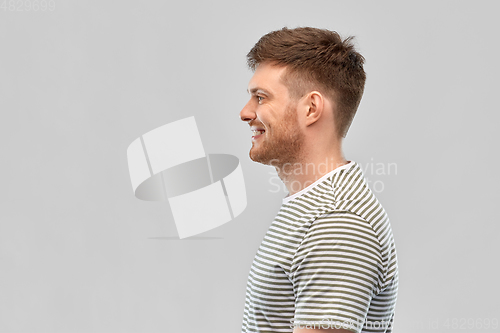 Image of smiling young man in striped t-shirt