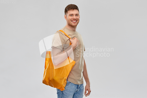 Image of man with reusable canvas bag for food shopping