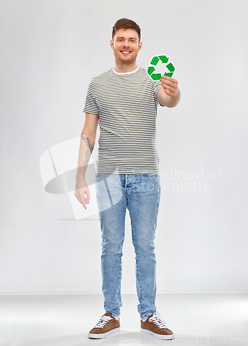 Image of smiling young man holding green recycling sign