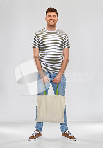 Image of man with reusable canvas bag for food shopping