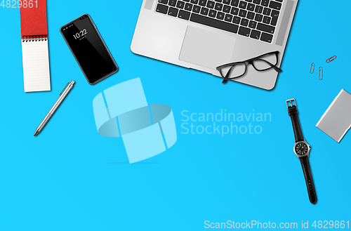 Image of Office desk mockup top view isolated on blue