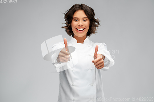 Image of smiling female chef in toque showing thumbs up