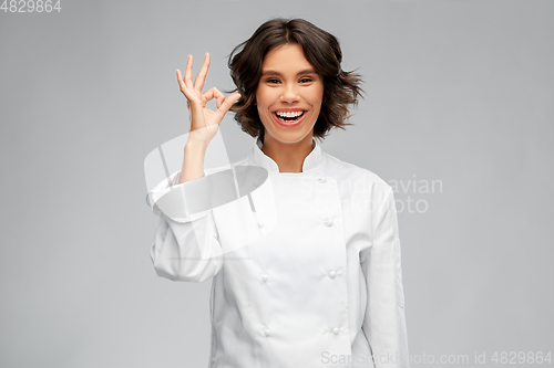 Image of happy smiling female chef showing ok hand sign