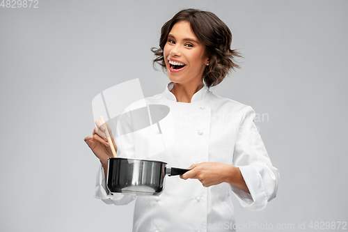 Image of happy smiling female chef with saucepan