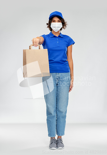 Image of delivery woman in face mask with food in paper bag