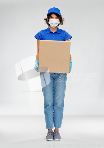 Image of delivery woman in face mask holding parcel box