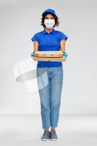 Image of delivery woman in face mask with pizza boxes