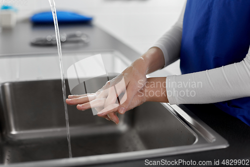 Image of doctor or nurse washing hands with liquid soap