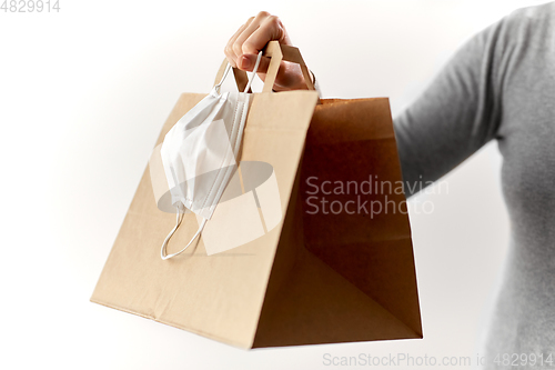 Image of woman with shopping bag and face protective mask