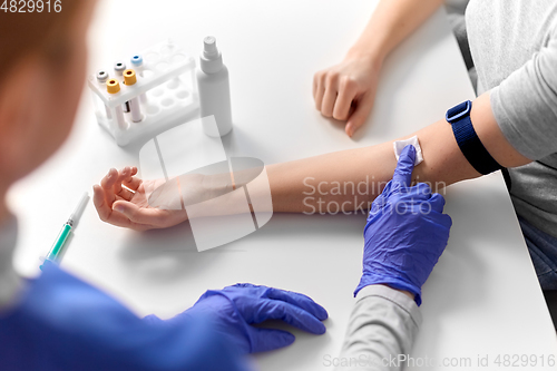 Image of doctor and patient taking blood for test