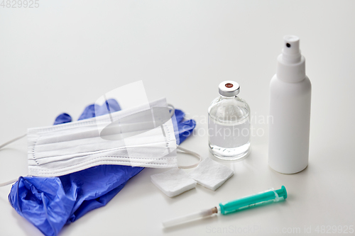 Image of syringe, medicine, wound wipes, gloves and mask