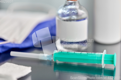 Image of syringe, medicine, wound wipes, gloves and mask