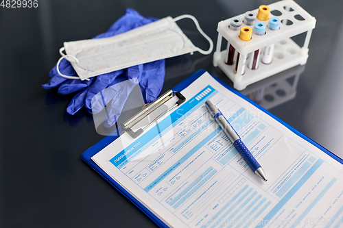 Image of medical report, blood tests, gloves and mask