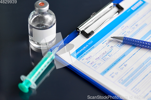 Image of medical report, pen, syringe and medicine