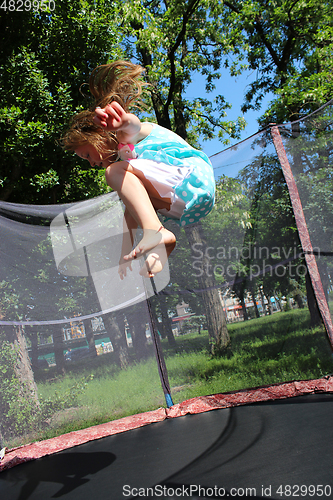 Image of girl jumps on the trampoline