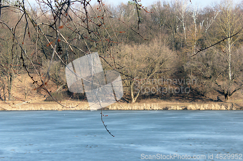 Image of spring river with melting of ice and forest