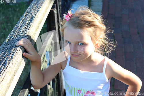 Image of little fashionable girl with beautiful modern coiffure