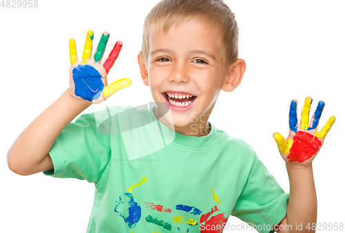 Image of Portrait of a cute boy playing with paints