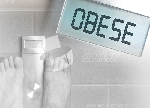 Image of Man\'s feet on weight scale - Obese