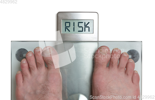 Image of Man\'s feet on weight scale - Risk