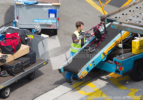 Image of AMSTERDAM, NETHERLANDS - JUNE 29, 2017: Loading luggage in airpl