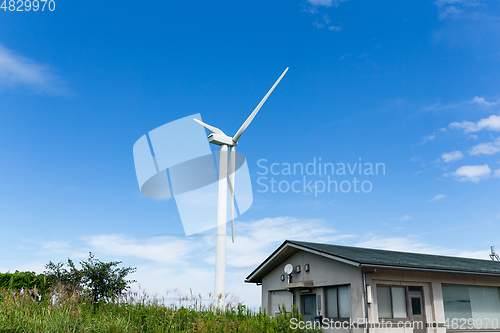 Image of Wind turbine  and house